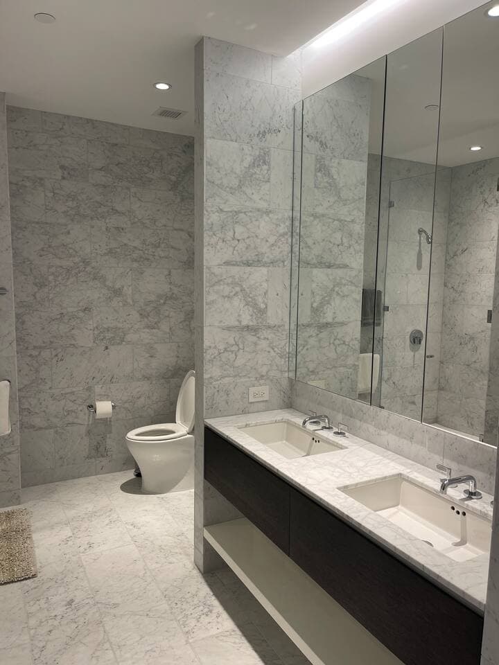 Beautifully marbled primary bathroom with double sinks, shower and bath