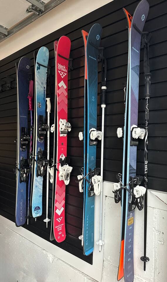 Garage has ski racks for 8 pairs of skis and poles